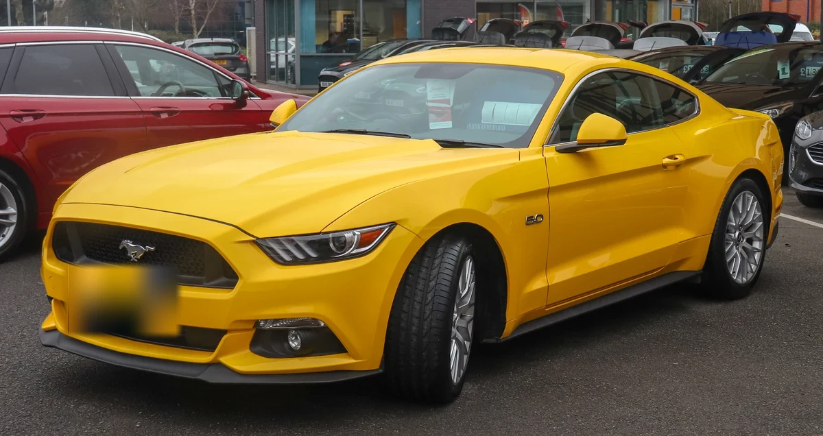 Yellow car with its foreground license plate blurred